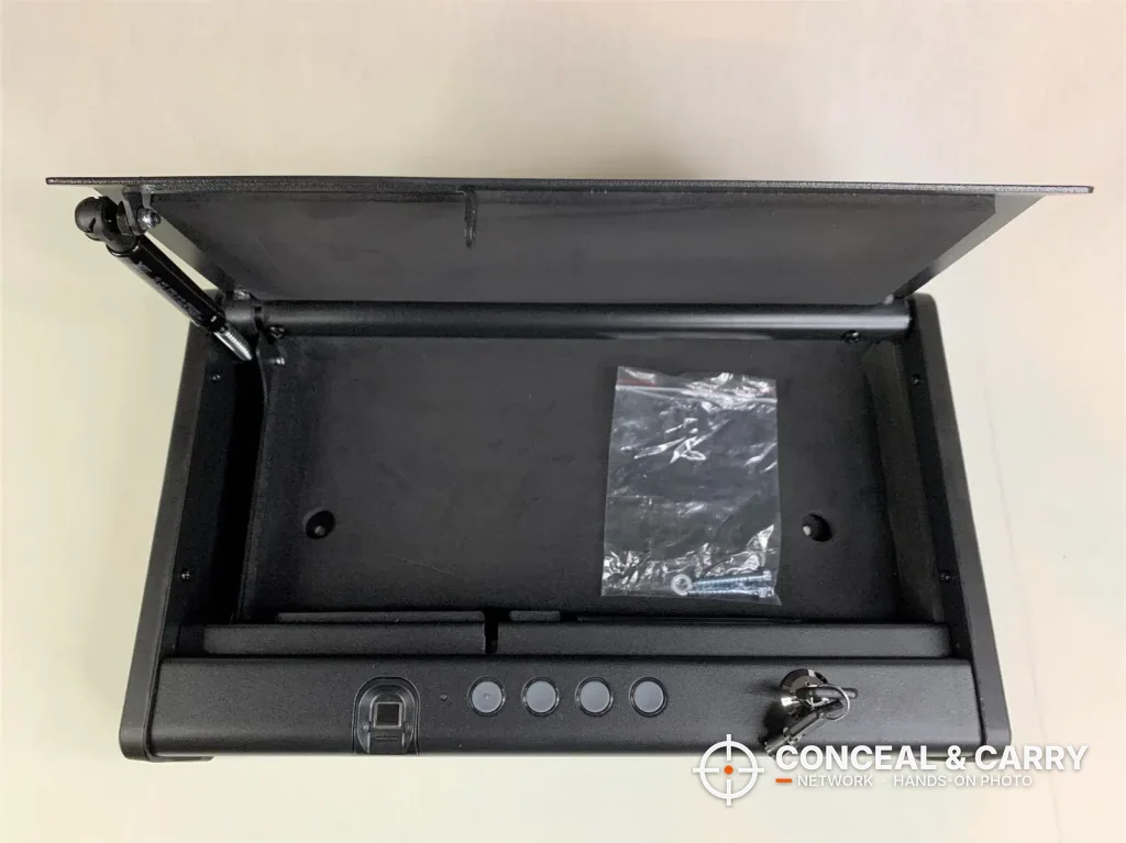 SentrySafe QAP2BLX lid open on an empty interior with a bag of hardware inside