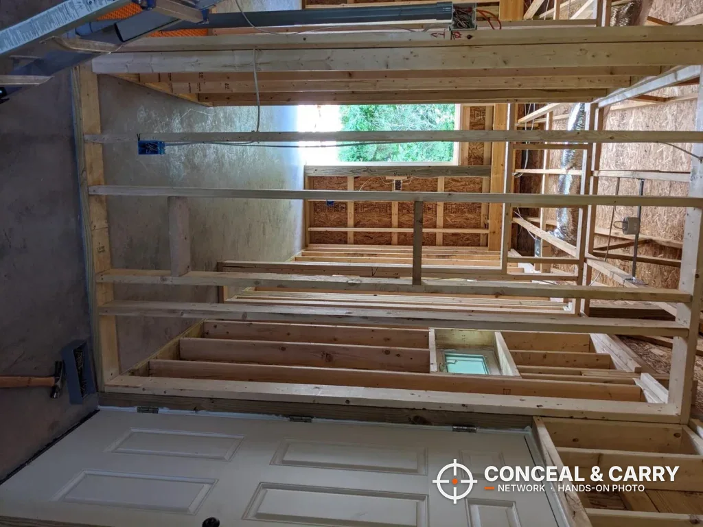 Unfinished stud walls like the ones a SnapSafe in-wall safe mounts between