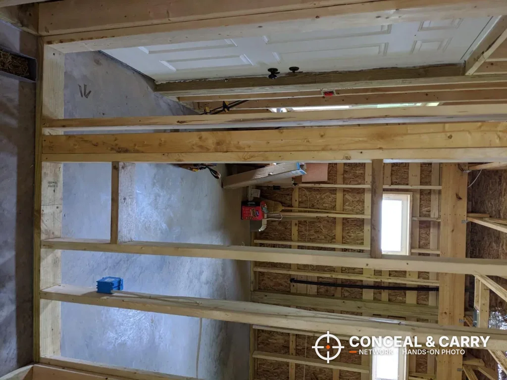 Stud wall with a blue electrical box, a hazard to check before a SnapSafe in-wall install