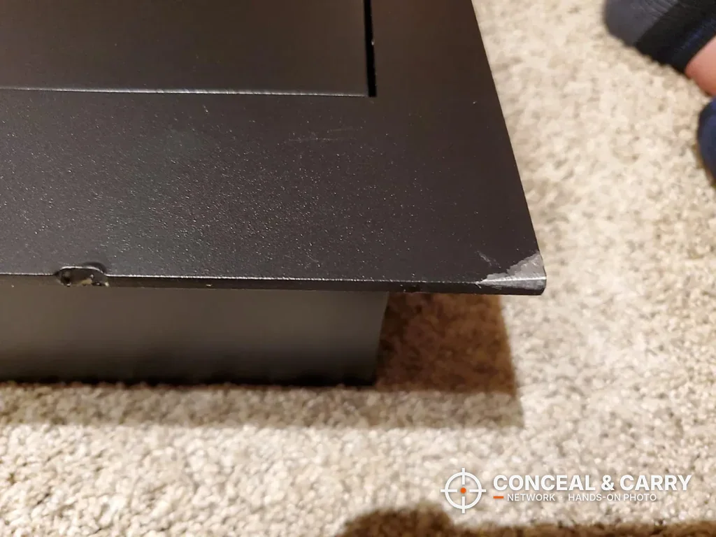 Close-up of the front flange corner on the SnapSafe in-wall long gun safe
