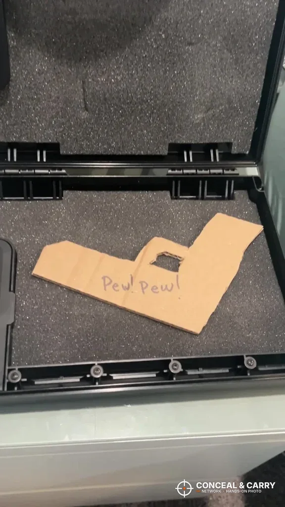 Cardboard pistol outline on the foam floor of an open StopBox USA