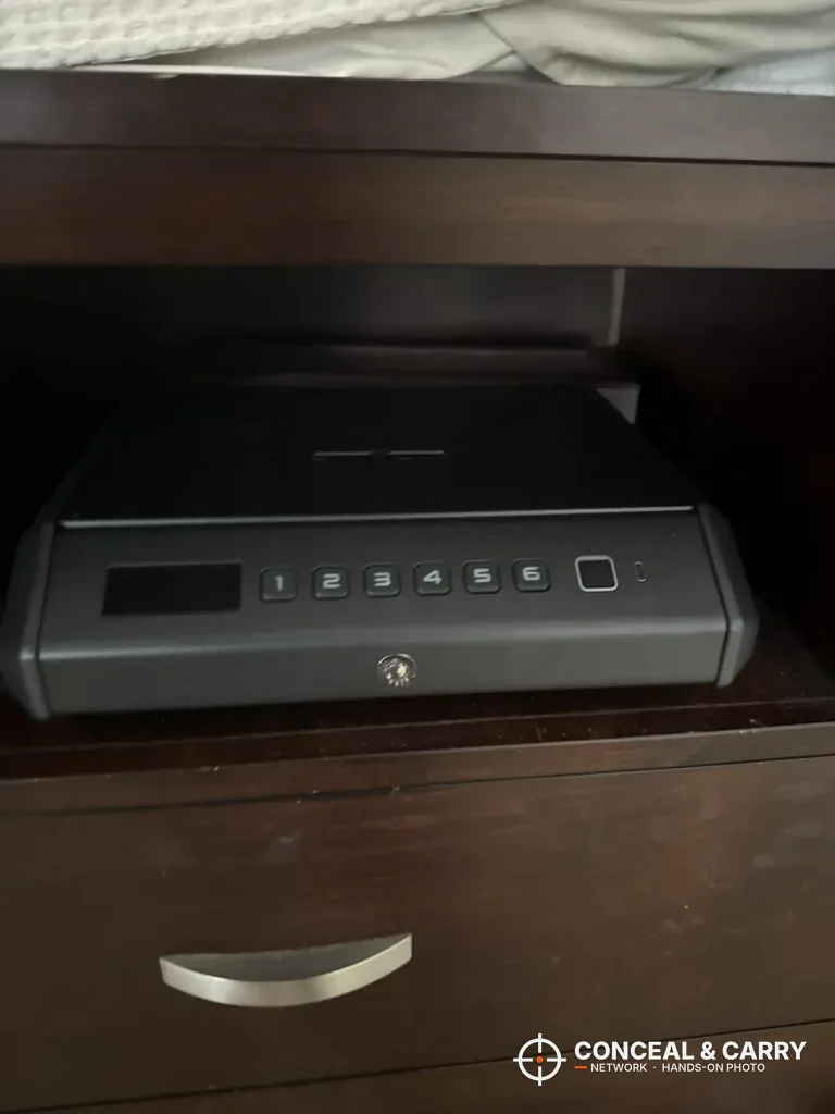 TOPMEDA biometric pistol safe on an open nightstand shelf