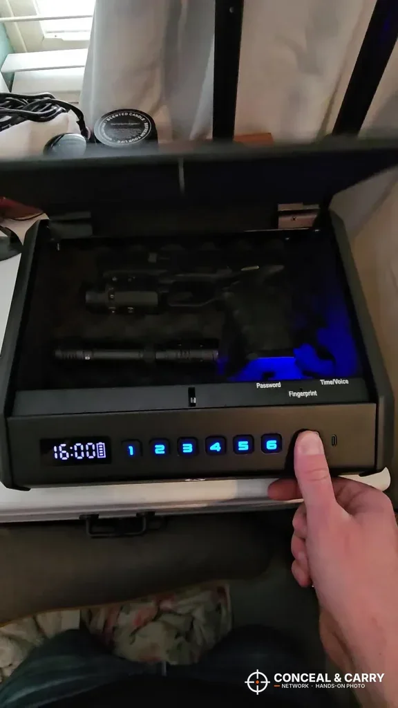 Thumb on the TOPMEDA safe fingerprint pad with the keypad lit blue
