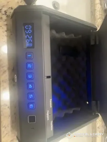 TOPMEDA pistol safe open with the blue interior light on the foam