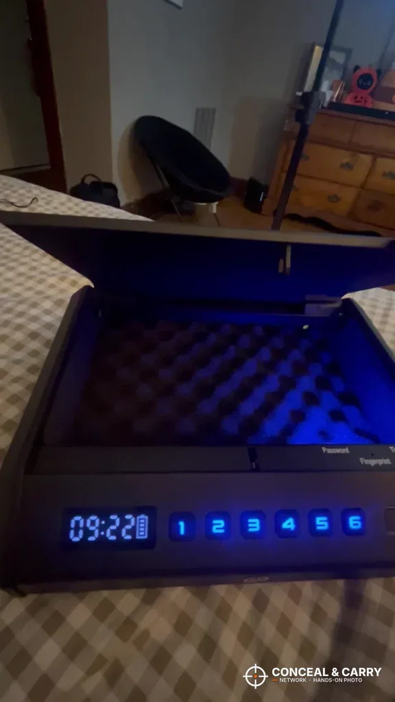 TOPMEDA safe open on a bed with the interior light on