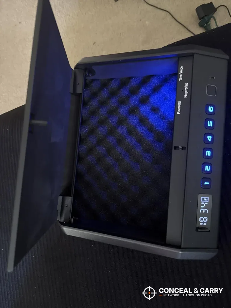 Empty TOPMEDA safe interior lit blue with the lid raised