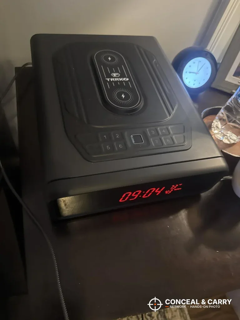 TRRKO auto-open charging safe on a nightstand with the front clock lit