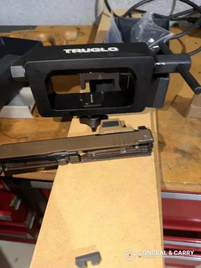 TRUGLO sight tool on the workbench with a pistol slide below it