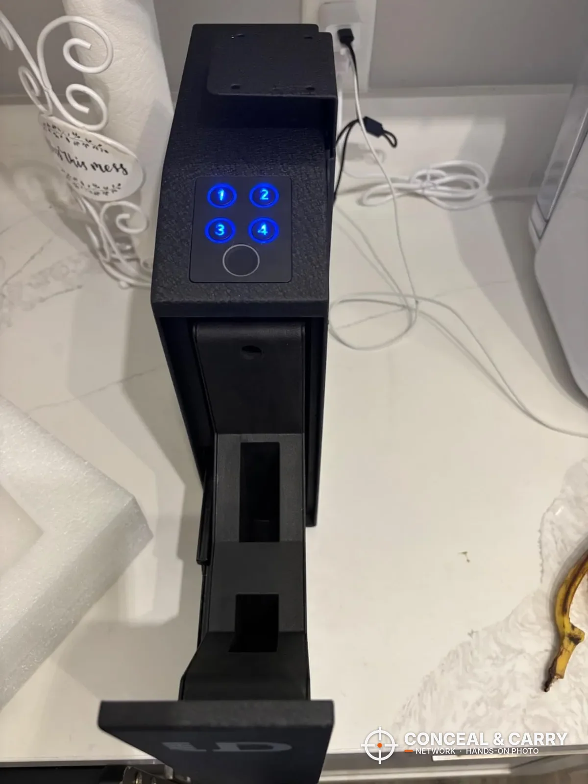 Urban Deco biometric pistol safe with the keypad lit blue and the door slid open