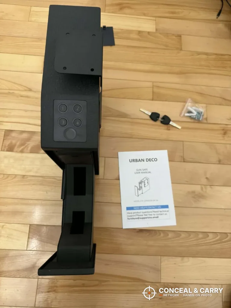 Urban Deco biometric pistol safe unboxed with keys, a parts bag and the manual