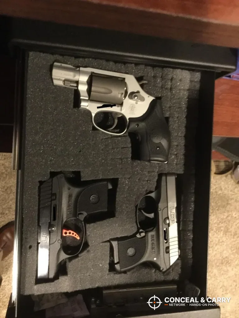 V-Line Slide-Away drawer with a revolver and two compact pistols in cut foam