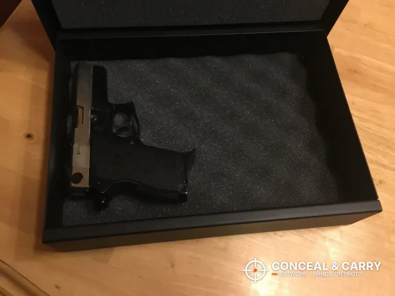 V-Line Top Draw open with a pistol lying in the egg-crate foam