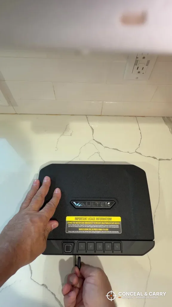 Hand plugging a power cable into the Vaultek 20 Series Biometric