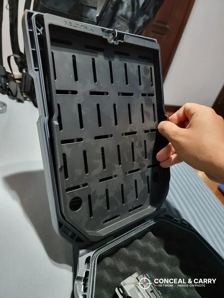Hand lifting the slotted tray in the Vaultek LifePod 20
