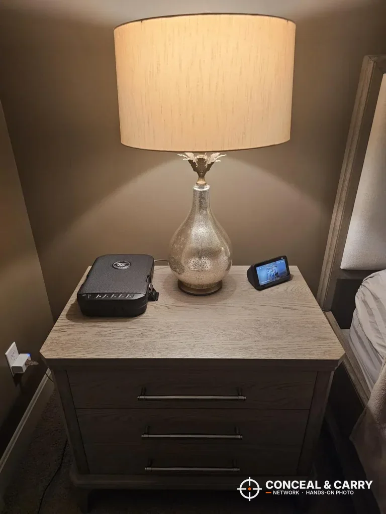 Vaultek LifePod 20 Biometric on a bedside table under a lamp