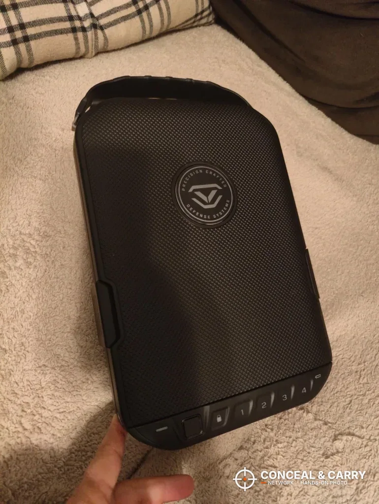 Closed Vaultek LifePod 20 Biometric held in hand with the front keypad edge showing