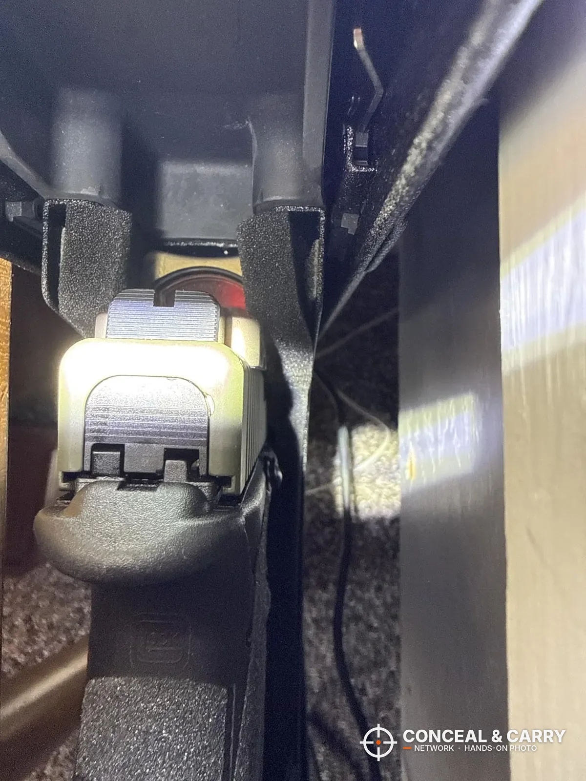 Pistol rear sights lit up by the Vaultek Slider Series interior light
