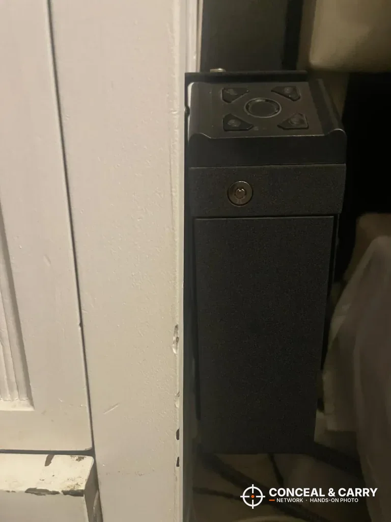 VERPROOF gun safe standing closed in a narrow gap beside a door frame