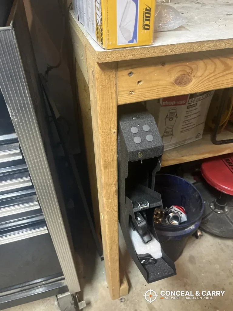 VERPROOF keypad gun safe fastened to a workbench leg with the drawer open