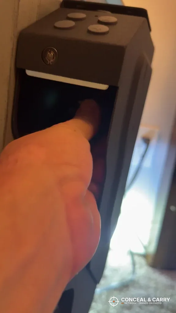 Finger reaching into the open drawer of the VERPROOF keypad gun safe