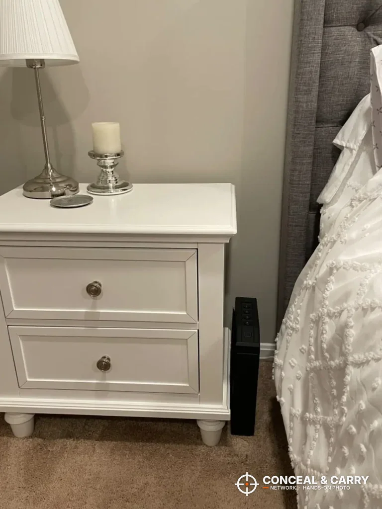 VoleStay slider safe tucked beside a white nightstand next to the bed