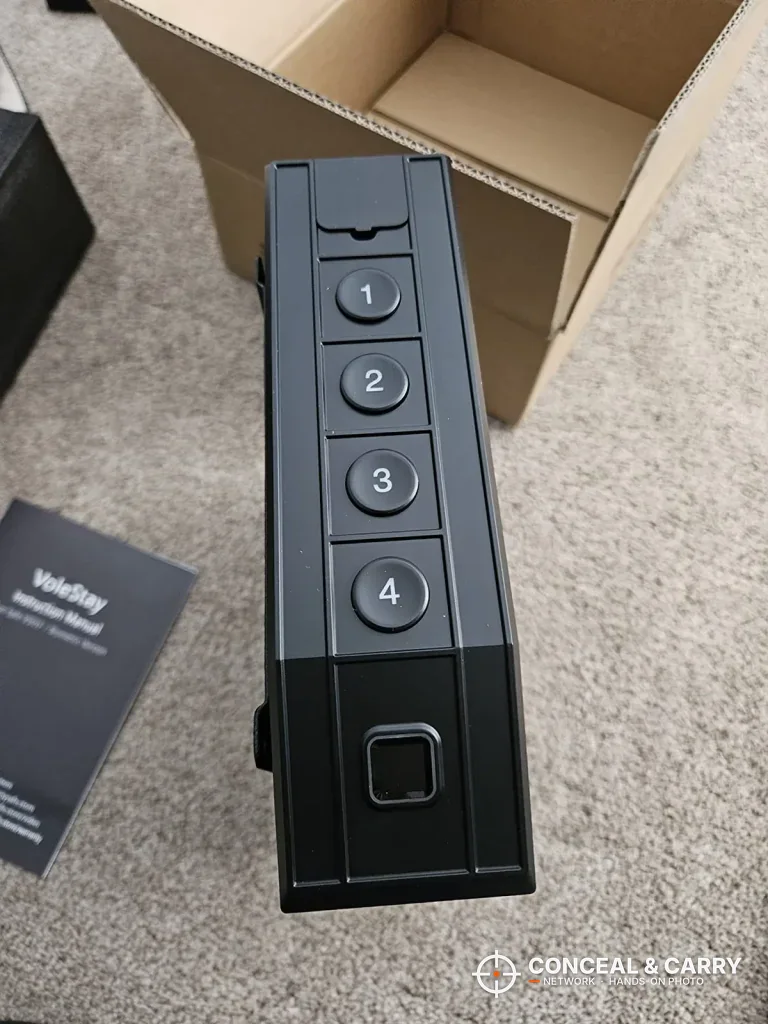 VoleStay keypad edge beside its shipping carton and manual