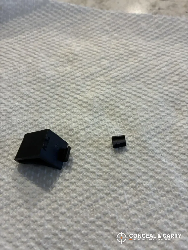Two small black plastic pieces from the Wasatch 18EGW on a towel
