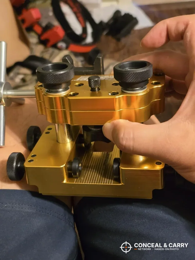 Hands holding the Wheeler Armorer's Handgun Sight Tool before setup