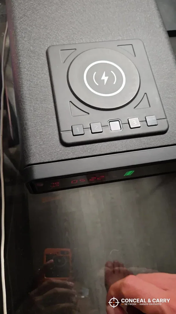 Close-up of the XDeer safe wireless charging pad above the keypad