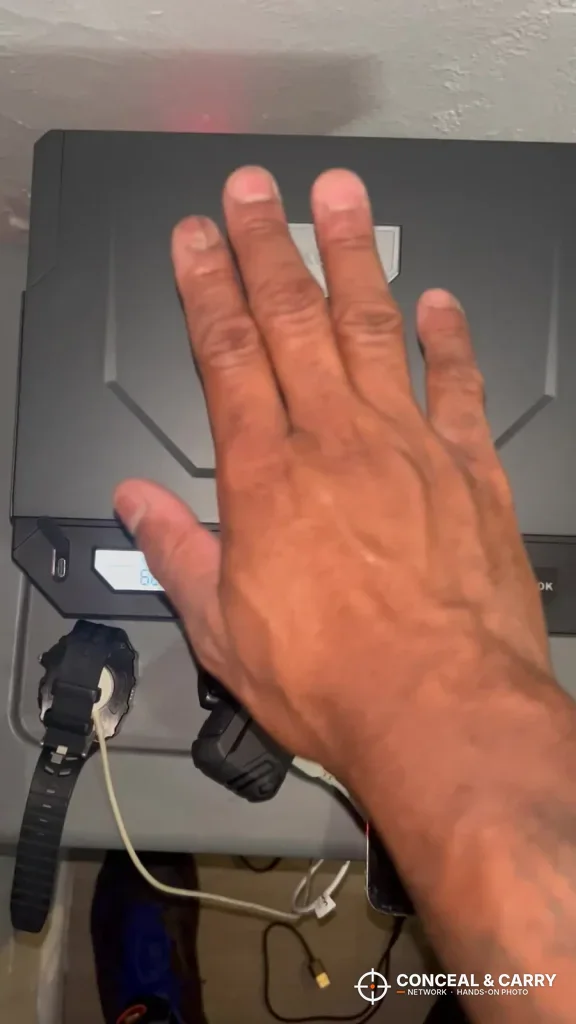 Open hand held over the XEGIS palm vein scanner
