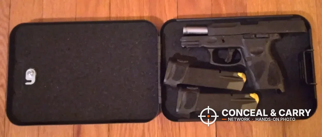 Younion portable pistol safe open with a compact pistol and two magazines in the foam