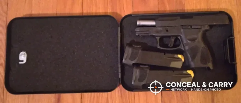 Younion portable pistol safe open with a compact pistol and two magazines in the foam