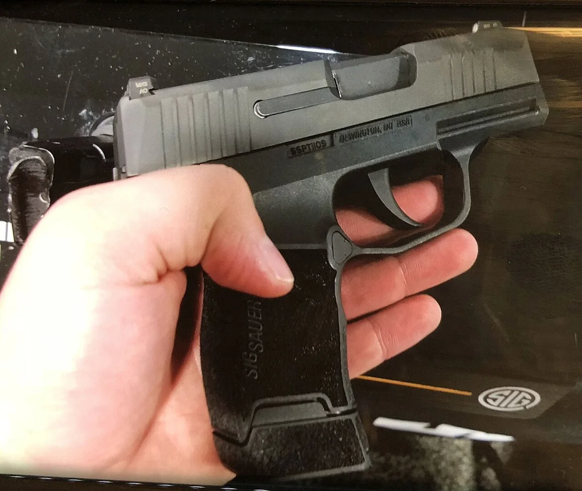 SIG Sauer P365 micro-compact 9mm pistol held in a hand to show its size